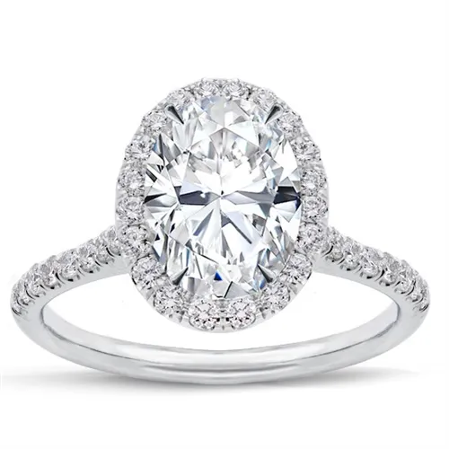 Oval halo engagement ring mounting with pave diamonds